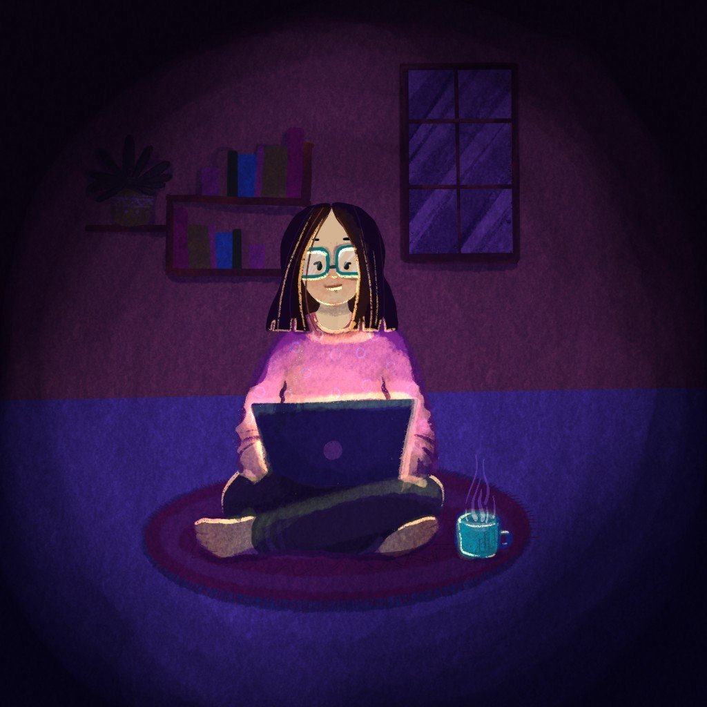 Person sitting with a laptop in a calm, cozy room at night